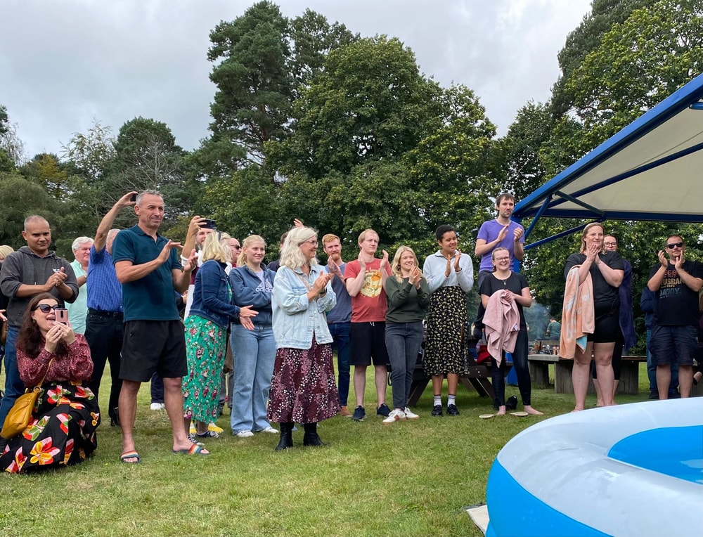 Friends from Vineyard25 celebrating a baptism together outdoors.
